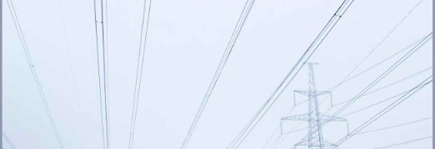 Transmission lines running through a snowy field 