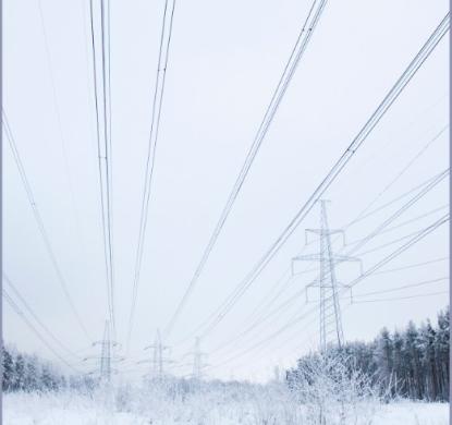 Transmission lines running through a snowy field 